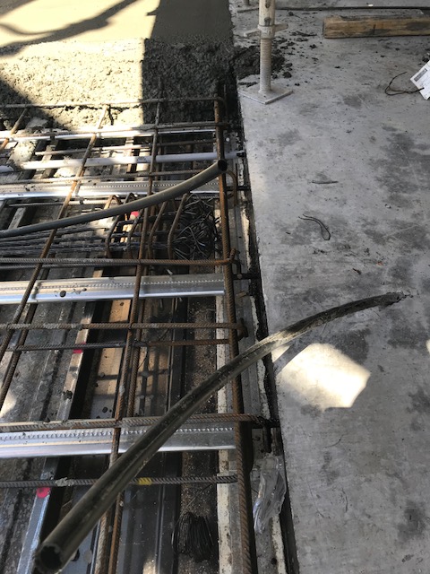 A construction joint in slabs is where the construction of two portions meet.  This is an example of a construction joint in a post-tensioned slab with the second pour being freshly poured against the first pour.